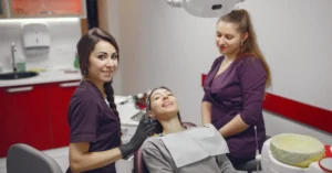 Dental team assisting patient during treatment visit